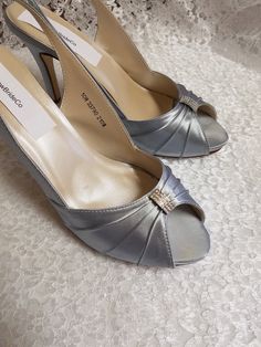 "Beautiful silver heels, sample sale, they been worn for a short time to take pictures, the outer sole has walk on marks but, other than that shoes are in perfect condition! Price reflects comment above. Thank you! Only one pairs Size: 10 Heel: 3 1/4\" Inside length: 10 5/8\" PLEASE MEASURE YOUR FEET LENGTH TO ENSURE FIT. FINAL SALE, NO RETURNS, NO EXCHANGES, NO EXCEPTIONS. PLEASE CONTACT FOR ANY ADDITIONAL QUESTIONS OR, CONCERNS. THANK YOU!" Ivory High Heels, Hot Pink Butterfly, Satin Shoes, Sample Sale, Silver Heels, Womens Wedding Shoes, Walk On, Wedding Shoes, Block Heels