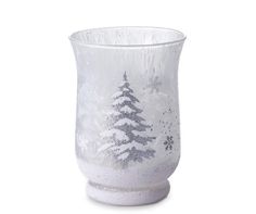 a frosted glass vase with snow covered trees on it's sides and silver glitter accents