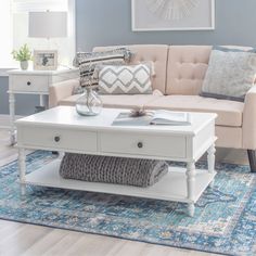 a living room with blue walls and white furniture