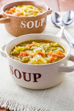 two bowls of soup sitting on top of a white tablecloth next to each other