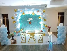 an event with balloons and decorations on the wall, including a stage set up for a party