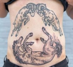 a woman with tattoos on her stomach has two goats in the shape of a circle