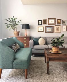 a living room filled with furniture and pictures on the wall