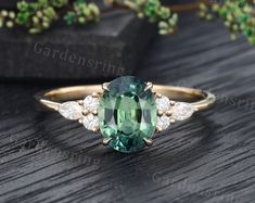 an oval cut green and white diamond ring