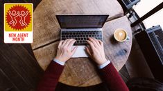 a person sitting at a table with a laptop on their lap and coffee in front of them