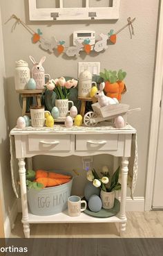 an easter table with eggs, carrots and bunnies