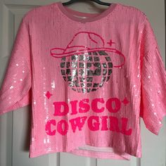 Mainstrip Hot Pink Sequin Disco Cowgirl Cropped Oversized Top, Size Large, Nwt. Casual Pink Tops For Party Season, Spring Disco Style Short Sleeve Tops, Spring Short Sleeve Disco Tops, Trendy Pink Tops For Party Season, Pink Letter Print Top For Party, Pink Letter Print Party Top, Pink Short Sleeve Top For Party Season, Pink Sequined Crew Neck Top, Pink Glitter Print Party Top