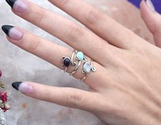 Cat Ring Details:-Choice of Natural Rainbow Moonstone, Dominican Larimar, or Natural Amethyst- 12mm face height- 2mm smooth round band- .925 solid sterling silver- Available in US ring sizes 4-10.5 with 1/2 sizes. 💜Connect with us on Instagram @a_wild_violet for sales and giveaways!**All items are in stock and ship within 2-5 business days from received payment (excluding Saturday/Sunday) from the US. If you are within the US please expect 3-7 business days for shipping transit and delivery. In Adjustable Stackable Round Moonstone Ring, Adjustable Amethyst Ring With Natural Stones, Mystical Round Natural Stones Jewelry, Mystical Round Natural Stone Jewelry, Purple Moonstone Round Jewelry, Mystical Style Moonstone Ring With Natural Stones, Round Moonstone Gemstones, Cat Ring, Natural Rainbow