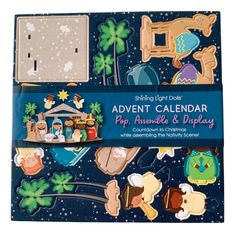 an assortment of wooden magnets with nativity and christmas scenes on them in a blue box