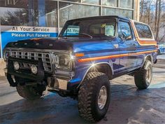 a blue truck parked in front of a building