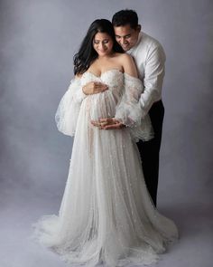 Capture the radiant beauty of pregnancy with our Gorgeous Ivory Pearls Tulle Maternity Dress. Crafted with delicate tulle and adorned with shimmering pearls, this off-shoulder maternity gown exudes elegance and charm. Perfect for baby showers and maternity photography, its ethereal design creates timeless and enchanting memories. Elevate your maternity style with this exquisite ensemble, celebrating the journey of motherhood with grace and sophistication. Specifications: Technique Beaded Materia Off Shoulder Maternity Dress, Tulle Maternity Dress, Fiesta Shower, Ethereal Design, Studio Maternity Photos, Shower Photography, Baby Shower Photography, Radiant Beauty, Custom Bridesmaid Dress