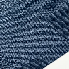 a close up view of a blue tie on a white background with an interesting pattern