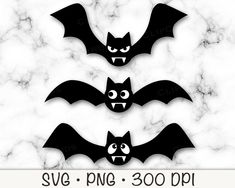 three bats with mouths and fangs cut out on white marble background for halloween decoration or scrapbooking