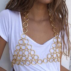 90s inspired racerback Chain Mail bra, sure to turn heads. Wear it over a tight mesh bodysuit and bellbottoms or dressed down with a basic tee and boyfriend jeans. This unique piece fits over the head and is adjustable at the bust. Available in gold or silver. Materials: Stainless Steel/ 18K Gold Plating Size: Based off bust size *Hypoallergenic, Lead and Nickel Free, Tarnish Resistant Care: Our jewelry is designed to be water-resistant, so you don't have to worry about taking it off when you're Trendy Summer Party Body Chain, Gold Body Chain For Summer Festivals, Fitted Gold Body Chain For Night Out, Fitted Body Chain For Club, Gold Stretch Crop Top For Summer, Summer Club Body Chain, Trendy Gold Body Chain For Summer, Summer Festival Fitted Body Chain, Fitted Body Chain For Summer Night Out