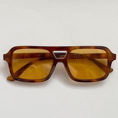 This vintage-inspired aviator is made from brown tort shell acetate and paired with a tan / orange coloured lens. This style is unisex. Dimensions:  Temple length: 14.5cm Lens width: 5.3cm Height: 4.1cm High Quality with UV protection.  Sunglasses are carefully packaged in bubble wrap to ensure they arrive to you in perfect condition 99p UK Shipping We ship using Royal Mail 2nd class and dispatch the same working day if ordered before 2pm. There is also an option at checkout to upgrade your ship Brown Lens Sunglasses, Sunglasses Orange Lens, Retro Aviator Sunglasses With Tinted Square Frame, Retro Aviator Sunglasses With Tinted Square Lenses, Brown Aviator Sunglasses With Anti-reflective Square Frame, Retro Square Frame Aviator Sunglasses With Tinted Lenses, Brown Square Frame Aviator Sunglasses With Anti-reflective Coating, Brown Square Frame Anti-reflective Aviator Sunglasses, Brown Square Frame Aviator Sunglasses With Uva Protection