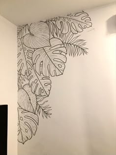 the wall is decorated with black and white leaves