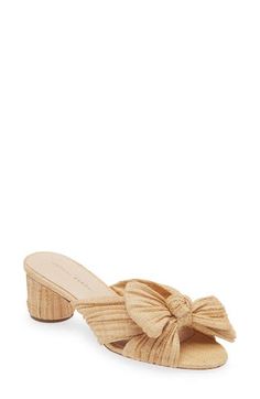 Woven raffia brings stunning texture to a weekend-ready sandal featuring a wrapped column heel and an artfully knotted bow over the toe. 2 1/4" heel (size 8.5) Synthetic upper/cotton lining/leather sole Imported Chic Natural Straw Heels, Chic Sandals With Wooden Heel And Straw Material, Chic Heels With Wrapped Heel In Straw, Chic Straw Heels With Wrapped Heel, Elegant Summer Straw Heels, Elegant Natural Heels For Vacation, Natural Straw Heels With Wrapped Heel, Elegant Straw Heels With Block Heel, Elegant Heels With Wooden Heel For Vacation