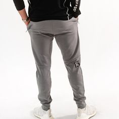 Gear up to conquer the day in our Valor Combat Joggers. Constructed from a blend of 65% Cotton and 35% Polyester, these stylish joggers provide both durability and comfort. Elastic waistband with an adjustable screen printed morse code drawstring for a customized fit, plus deep side pockets to keep your essentials secure. Silicone Volition America Wing logo and '13' representing the 13 folds of our flag are the patriotic details that make these so special. Ideal for an active lifestyle and desig Breathable Cotton Sportswear Bottoms, Urban Style Cotton Sports Joggers, Urban Cotton Joggers For Sports, Urban Style Cotton Joggers For Sports, Gray Cotton Activewear For Training, Gray Athletic Fit Activewear For Casual Wear, Breathable Gray Activewear For Streetwear, Gray Sporty Pants With Comfort Waistband, Sporty Gray Pants With Comfort Waistband