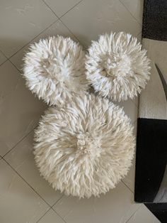 a pair of scissors laying on top of a white rug next to a black and white area rug