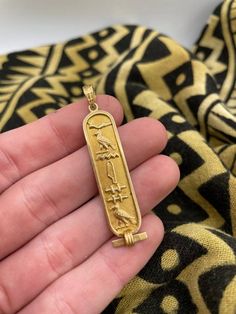 18k gold Egyptian pendant Ornate bale  Stamped  Features Variety of Hieroglyphics  Pretty cool and Unique 2 inches long 3.8 grams Carved Yellow Gold Amulet Jewelry, Symbolic Carved Gold Jewelry, Gold Rectangular Pendant With Etched Details, Gold Etched Rectangular Pendant Jewelry, Ancient Etched Gold Jewelry, Antique Gold Ankh Jewelry, Egyptian Pendant, Egyptian Hieroglyphics, Pretty Cool