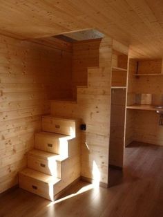 a room with wooden walls and stairs in it