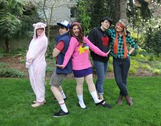 group of people in costumes standing on grass with one person wearing a costume and the other holding his hand out