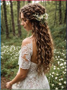 a woman with long curly hair wearing a white dress in the middle of a forest