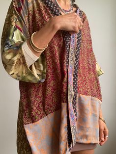 This is colourful, light oversized silk kimono shirt  patchwork of different vintage silk materials  very soft and flowy  made for both men and woman  nice looking with skirt as well as trousers or shorts, can be used all year round, as a cover up layered over a long sleeve  super comfy, hippie boho style, great for summer festivals, travels, or every day MEASURE free size MATERIAL *silk More boho style ideas at  https://www.etsy.com/shop/AltheaStores Thank you for looking Boho Vintage Clothing, Oversized Multicolor Bohemian Tops, Oversized Patchwork Tops For Layering, Bronze Blouse, Oversized Patchwork Long Sleeve Shirt, Oversized Bohemian Patchwork Tops, Funky Party, Silk Long Sleeve Kimono With Patchwork, Long Sleeve Silk Kimono With Patchwork