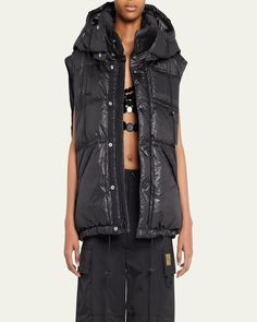 Marc Jacobs Puffer vest with logo embroidered patch on chest    High neckline; snap button front    Sleeveless    Hip flap buttonclosure pockets    Semifitted    Drawstring hem    Polyester/nylon    Feather/Down fill    Silk lining    Metal trim    Made in Italy Black Sleeveless Vest With Padded Collar, Nylon Vest With Padded Collar For Streetwear, Sleeveless Nylon Outerwear For Streetwear, Spring Nylon Vest With Pockets, Sleeveless Nylon Outerwear With Padded Collar, Sleeveless Nylon Vest With Padded Collar, Fall Vest With Detachable Hood, Sleeveless Vest With Detachable Hood For Fall, Fall Sleeveless Vest With Detachable Hood