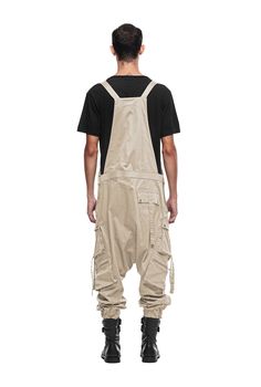 Overalls by JONNY COTA have arrived this season, crafted from luxe stretch cotton with customized Jonny Cota engraved hardware. Front pocket at chest Dual asymmetrical button slash pockets at hip Single cargo pocket on each leg Single pocket on back 95% cotton/5% spandex SIZE + FIT Loose, tapered, drop crotch fit Elastic cuffs The model is 6'2 and wearing a size M CARE Hand wash cold with colors, lay flat to dry Cargo Overalls, Men Jumpsuit, Cargo Pocket, Peter Pan, Stretch Cotton, Game Room, Lay Flat, Front Pocket, Athleisure