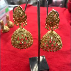 Gold Plated Jhumka Elegant Jhumkas With Zari Work For Festivals, Gold Bollywood Style Jhumkas, Elegant Jhumkas With Zari Work For Navratri, Elegant Zari Work Jhumkas For Navratri, Elegant Zari Work Danglers For Festivals, Elegant Festival Zari Work Danglers, Traditional Gold Jhumkas With Zari Work, Gold Cutdana Jhumkas For Eid, Temple Jewelry Style Jhumkas With Latkans