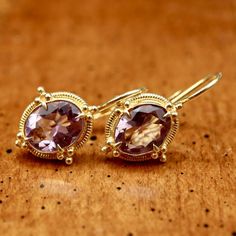 Renaissance jewelry is splendidly reborn. Our faceted amethyst ensemble belongs at a ball, or at least at a local disco. 24k gold over sterling silver granulated settings augment the brilliant sparkle of the faceted stones. European backs. Size: 1 Inch. Elegant Gold Amethyst Jewelry, Gold Amethyst Round Earrings, Luxury Gold Amethyst Earrings, Gold Amethyst Gemstone Earrings, Formal Gold Earrings With Gemstone Accents, Gold Earrings With Gemstone Accents, Gold Amethyst Earrings Fine Jewelry, Exquisite Gold Earrings With Gemstone Accents, Gold Amethyst Earrings With Gemstone Accents