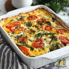 a casserole dish with tomatoes, broccoli and cheese