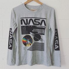 New, Never Worn Without Tags Nice Nasa Graphic Long Sleeved T-Shirt Sz: Small. Bust Measured From Pit To Pit Is 19”, Overall Length Is 25”. No Flaws. Gray Long Sleeve Tops With Graphic Print, Gray Long Sleeve Top With Graphic Print, Gray Slogan Top For Streetwear, Gray Graphic Print T-shirt For Fall, Gray Crew Neck Top With Logo Print, Fall Gray Graphic Print T-shirt, Trendy Gray Tops With Screen Print, Heather Grey Graphic Tee With Graphic Print, Heather Grey Graphic Tee With Print