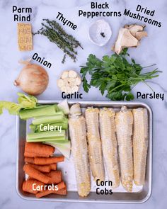 an assortment of vegetables on a tray labeled in the words carrots, celery, parsley and garlic