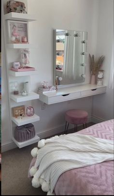 a bedroom with a bed, mirror and shelves on the wall next to each other