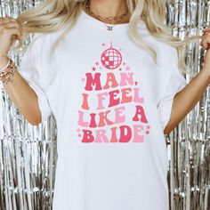 a woman wearing a t - shirt that says man, i feel like a bride