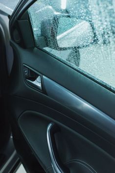 the inside of a car with rain on it