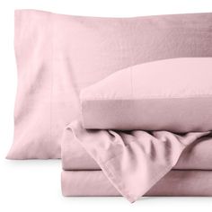 the sheets and pillow cases are folded up on top of each other, with pink linens