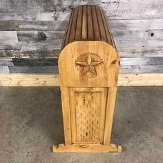 a wooden bench sitting on top of a cement floor