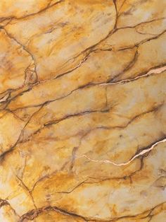 a close up view of the surface of a marbled table top with yellow and brown colors