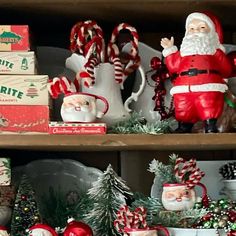 santa clause figurines and other christmas decorations are on display in a store shelf