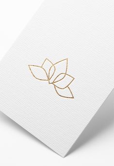 a gold leaf logo on white paper