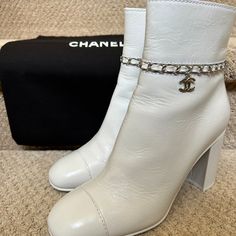 Chanel Calfskin White Ankle Boots With Cc Chain. These Were Bought And Worn Once For A Couple Of Hours On The Same Day. The Only Sign Of Wear Is Discoloration On The Sole From The Street! They Still Come In Original Packaging With Dust Bags. European Size 39. White Leather Boots With Ankle Strap, White Chanel Boots, Chanel Ankle Boots, Shoes Chanel, Chanel Boots, White Ankle Boots, Virtual Closet, Chanel Shoes, Bootie Boots