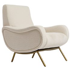 an upholstered lounge chair with gold legs