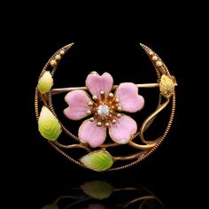 A Victorian 18k yellow gold crescent brooch with enameled flower and foliate designs featuring a single diamond in the center. SP274 Weight: 3.00 grams (Inclusive of all materials) Diamond (1) Old Mine Cut Color: H Clarity: SI1 Carat Weight: 0.20 ctw Yellow Gold Enamel Brooches Hallmarked, Yellow Gold Enamel Brooch Jewelry, Elegant Yellow Gold Enamel Brooches, Elegant Flower Enamel Pin Collectible, Unique Yellow Gold Enamel Brooch, Fine Jewelry Flower Brooch, Yellow Gold Enamel Brooches For Gifts, Elegant Enamel Flower Brooches, Art Nouveau Enamel Brooch Jewelry