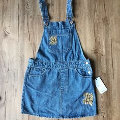 Brand New With Tags! Never Worn! Super Cute Denim Overalls With Golden Embroidered Flower Accents. The Embroidery Add Some Extra Style To The Traditional Overall Dress! Size: Small Casual Embroidered Medium Wash Denim Dress, Embroidered Denim Blue Dress, Embroidered Denim Dress For Summer, Casual Denim Blue Dress With Floral Embroidery, Casual Floral Embroidered Medium Wash Denim Dress, Embroidered Denim Dress In Blue, Casual Medium Wash Denim Dress With Floral Embroidery, Embroidered Blue Denim Dress, Blue Embroidered Denim Dress