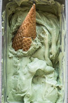 an ice cream container filled with green liquid