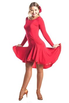 a woman in a red dress posing for the camera with her hands on her hips