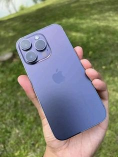 a person holding an apple phone in their hand with the camera on it's back